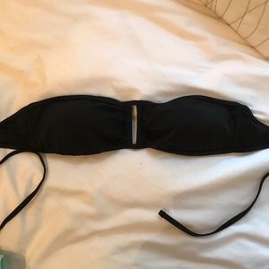 Black strapless swim top with cutout